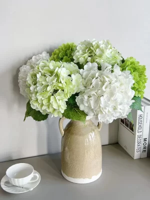 A vibrant floral arrangement featuring white artificial hydrangeas combined with hydrangeas in various colors. This elegant mix adds a dynamic and fresh look to any interior space, ideal for bringing a splash of color and charm.