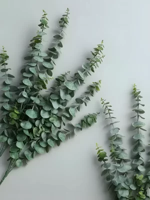 A close-up view of a highly detailed artificial eucalyptus stem, with lifelike leaves and natural textures, perfect for home or office decor, offering a realistic alternative to fresh plants.