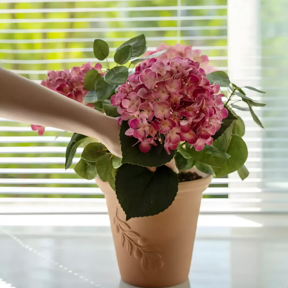 This large pink hydrangea arrangement, placed by a sunlit window, captures the beauty of natural light shining on the vibrant faux blooms. The soft light highlights the realism of the petals, creating a peaceful and inviting atmosphere.