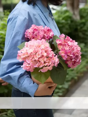 Bright and vibrant, this large artificial pink hydrangea arrangement adds a burst of color. The red brick ceramic pot gives the arrangement a sturdy and rustic feel, making it perfect for any room or garden.