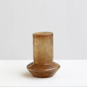 This amber-toned, cone-shaped glass vase stands at approximately 10.6 inches tall with a 7.9-inch diameter and features a sleek, modern look. Perfect for adding warmth and elegance to any room.