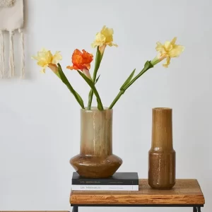 The combination of the amber cone-shaped and tall slim vases on a desk creates a sophisticated yet relaxed aesthetic, perfect for home offices or study spaces with a warm, rustic touch.