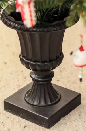 The black plastic pot base ensures stability and complements the tree’s classic design, adding a sleek, modern touch to its natural appearance. This durable pot base allows for easy placement anywhere in your home, blending seamlessly with a variety of interior styles.