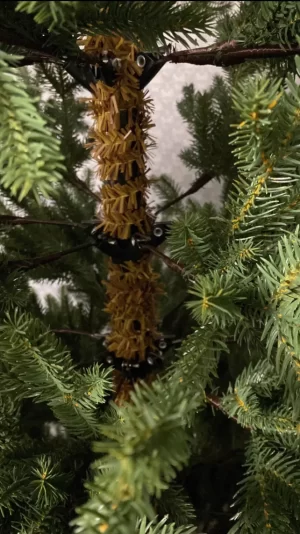 This close-up of the tree trunk reveals the sturdy iron framework that connects each branch. The careful construction ensures the tree is both realistic and durable, perfect for holiday use.