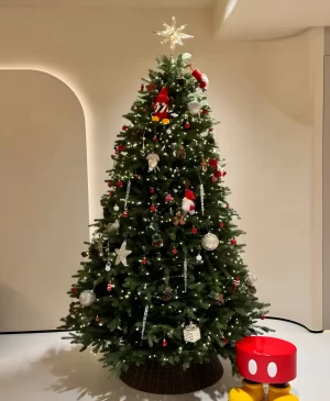 In this inviting bedroom, the Christmas tree is beautifully decorated with colorful ornaments and lights. Its festive charm brings warmth and joy, making it a delightful addition to your holiday celebrations.