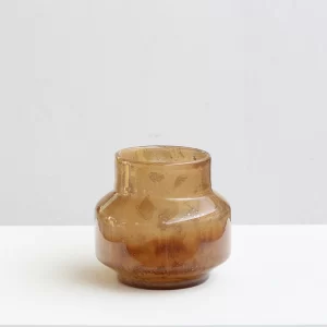 This round, low-profile amber vase stands about 8.3 inches tall with a diameter of 9.1 inches. Its wide form and rich color make it an inviting addition to any space.