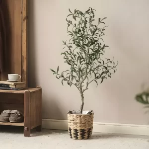 This scene showcases the artificial olive tree complementing rustic decor. The natural tones of the tree harmonize perfectly with the earthy palette of the room.